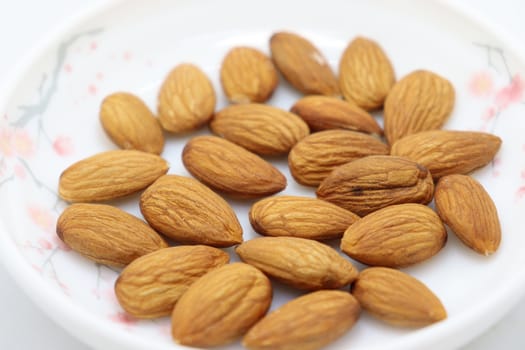 tasty and healthy brown colored almond stock on white background