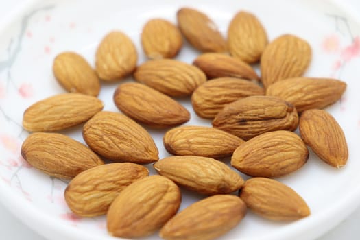 tasty and healthy brown colored almond stock on white background