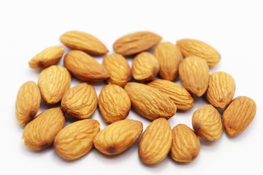 tasty and healthy brown colored almond stock on white background