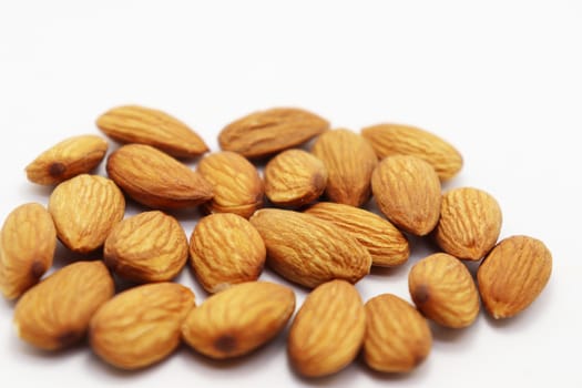 tasty and healthy brown colored almond stock on white background