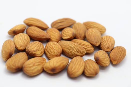 tasty and healthy brown colored almond stock on white background