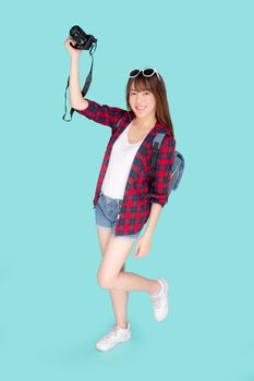 Beautiful young asian woman cheerful and enjoy travel trip summer isolated on blue background, asia girl having activity hobby take a photo holding camera, tourist journey in vacation and holiday.