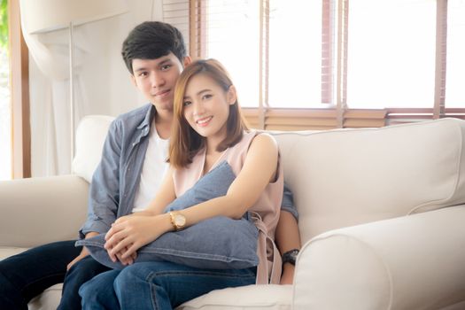 Beautiful portrait young asian couple relax and satisfied together in living room at home, family sitting couch confident with cheerful and happy with relationship, man and woman dating.