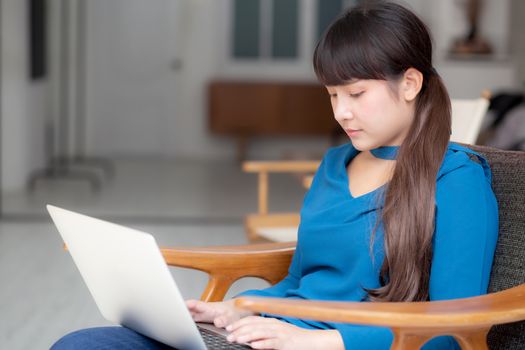 Business young asian woman freelance work on display laptop computer on chair, businesswoman check email, asia girl searching to internet communication and business concept.