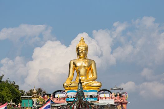 Chiang Rai Thailand 12.10.2015 large seated, crossed leg golden Buddha by river northern Thailand. High quality photo