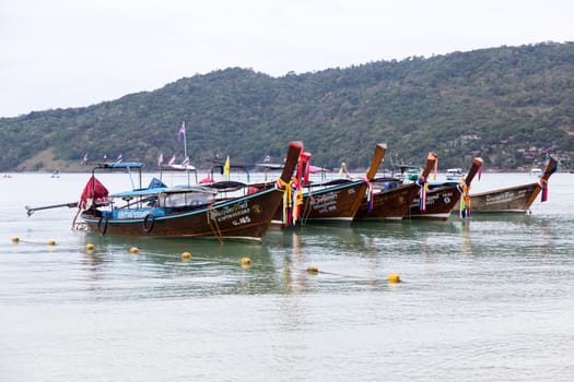 Phi Phi Thailand 12.6.2015 fishing boats in the bay with hills in the background. High quality photo