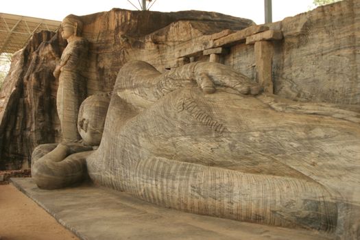 Polonnaruwa Sri Lanka Ancient ruins Statue of reclining Buddha laying down . High quality photo