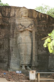 Polonnaruwa Sri Lanka Ancient ruins Statues of Buddha standing with crossed arms . High quality photo