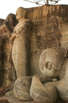 Polonnaruwa Sri Lanka Ancient ruins Statues of Buddha standing with crossed arms . High quality photo