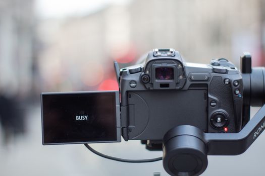 London, UK - February 14, 2020: Digital camera with black screen overlooking a British street. Camera capturing a cityscape from London. Photography and video equipment