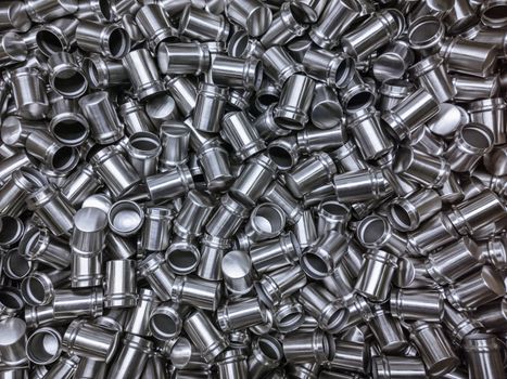 Shiny cold deformated cylindrical steel body parts flat background