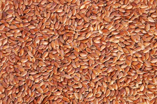 flax seeds close up, texture for brown food background.