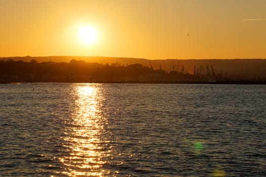 orange sunset on the sea, the setting sun is reflected in the water.