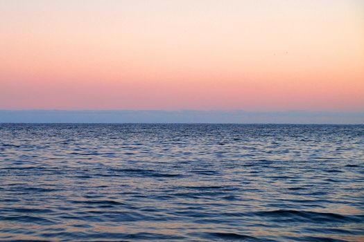 pink sunset sky, blue skyline and sea, natural background.