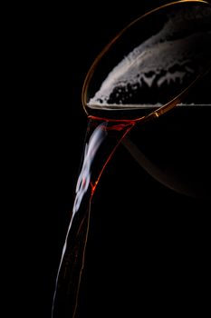 Black beer pouring on a black background