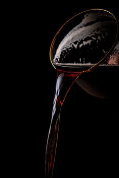 Black beer pouring on a black background