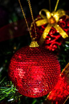 Christmas hanging decorations on fir tree. Decorated Christmas tree. Fir branch with Christmas baubles decorations.