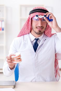 Arab dentist working on new teeth implant