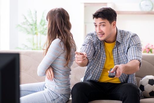 Family pair watching football at home