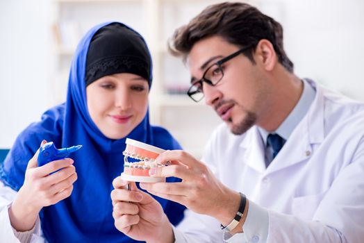 Dentist doctor and assistant working on new tooth implant