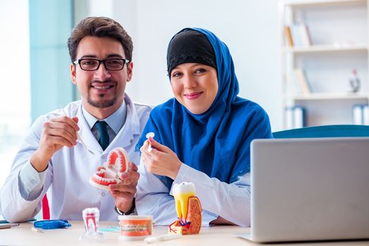 Dentist doctor and assistant working on new tooth implant