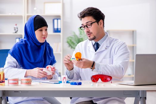 Dentist doctor and assistant working on new tooth implant