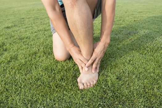 man ankle injury after running at Running field