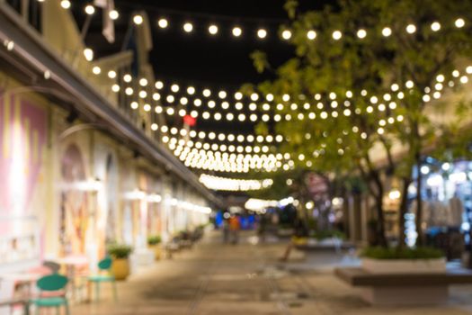 abstract blur image of night festival in a restaurant and market street walk with bokeh for background 