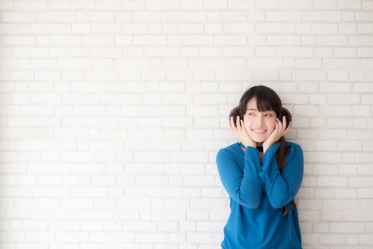 Portrait of beautiful young asian woman enjoy and happiness standing on gray cement texture grunge wall brick background, girl is a smiling and cheerful on concrete.