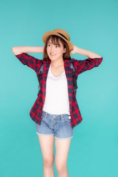 Beautiful portrait young asian woman holding hat smile expression cheerful and enjoy travel summer trip holiday in vacation isolated blue background, tourist happy asia girl confident and excited.
