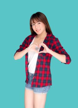 Beautiful happy young asian woman wear travel summer gesture heart shape with hand having confident isolated on blue background, asia teenager girl expression with cheerful and fun while trip.