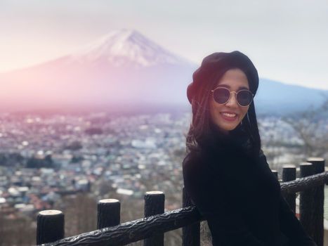 Beautiful smiling woman tourists are traveling and feel happy with Mt Fuji, Japan