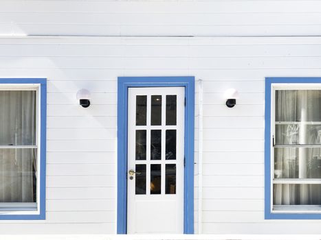 Vintage blue door with white house 