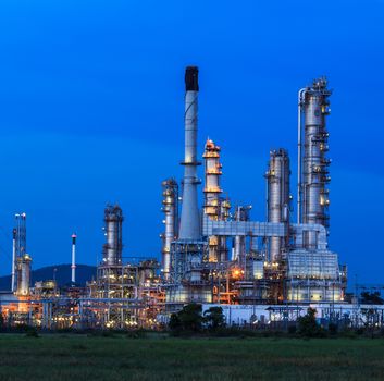 Oil refinery plant at twilight dark blue sky