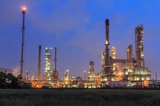 Oil refinery plant at twilight dark blue sky