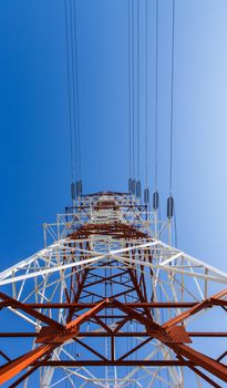 Power transmission lines against blue sky