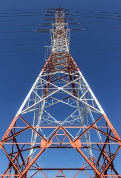 Power transmission lines against blue sky