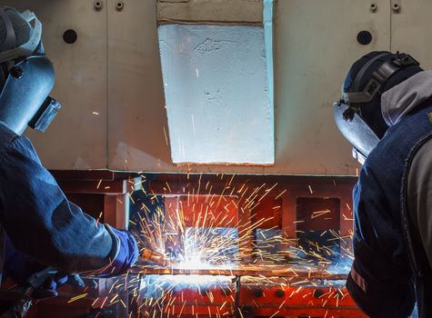 Team work welder steel in Industrial