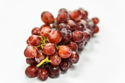 Red grapes on white background