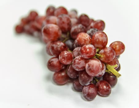 Red grapes on white background