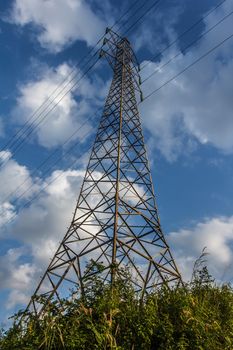 Power transmission lines against blue sky