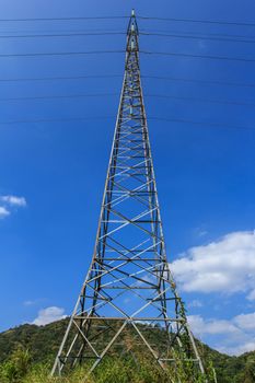 Power transmission lines against blue sky