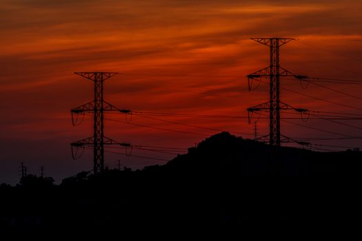 Power transmission line with the sun in the evening.