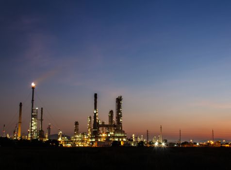 Oil refinery plant at twilight dark blue sky