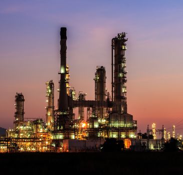 Oil refinery plant at twilight dark blue sky