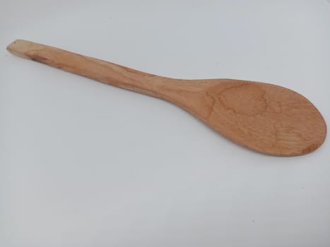 wooden spoon closeup on white background