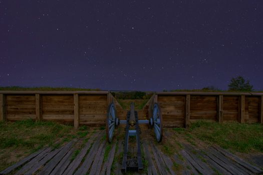 A Cannon at Valley Forge National Historical Park Looking Over a Wood Wall at Night With a Sky Full of Stars