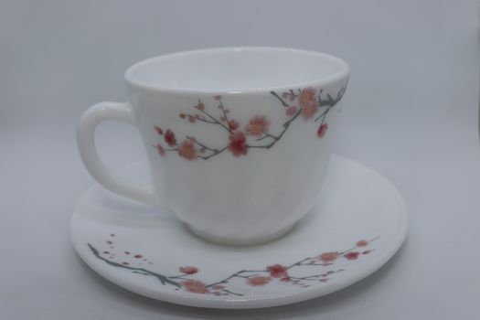 ceramic cup and plate closeup on white background