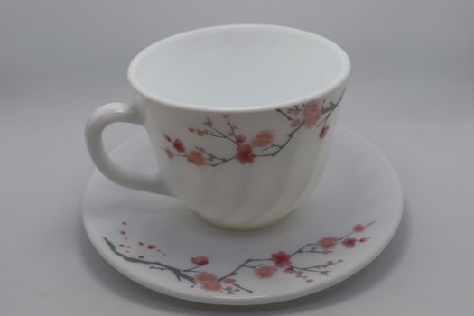 ceramic cup and plate closeup on white background
