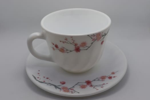 ceramic cup and plate closeup on white background